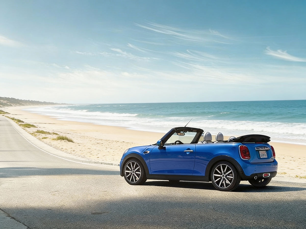 A stylish Mini Cooper convertible in bright red, parked with the top down, highlighting its sporty and compact appearance.