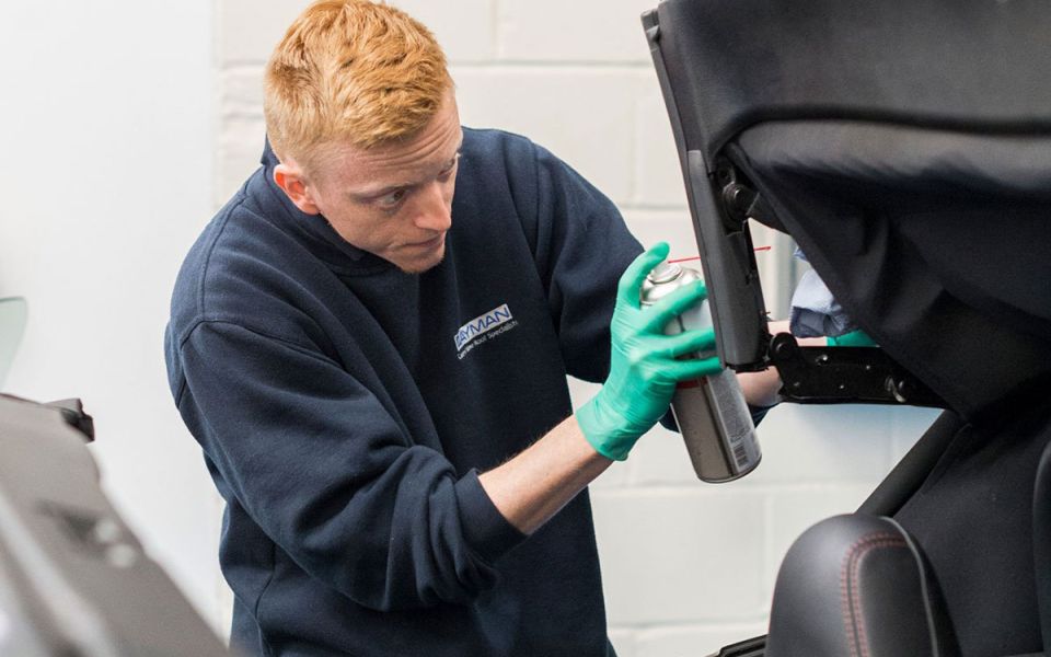 mechanic cleans soft top roof