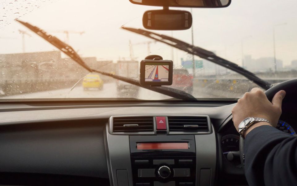 man drives car in rain