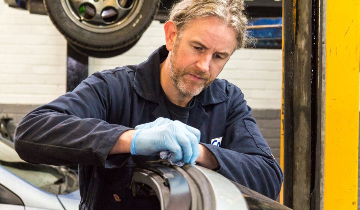 mechanic fixes convertible hood