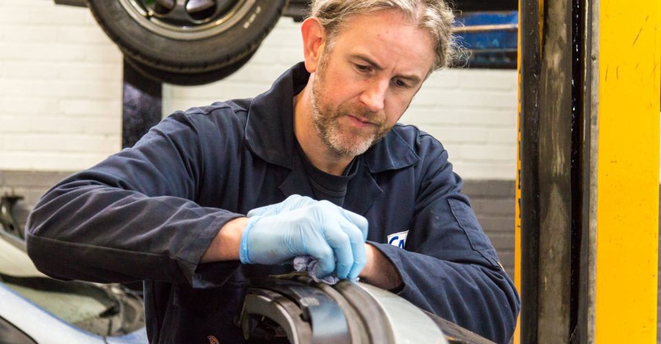 mechanic fixes convertible hood
